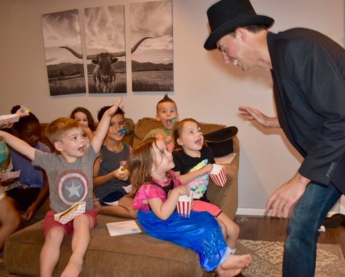 Magician Adam Stone with children's on holiday