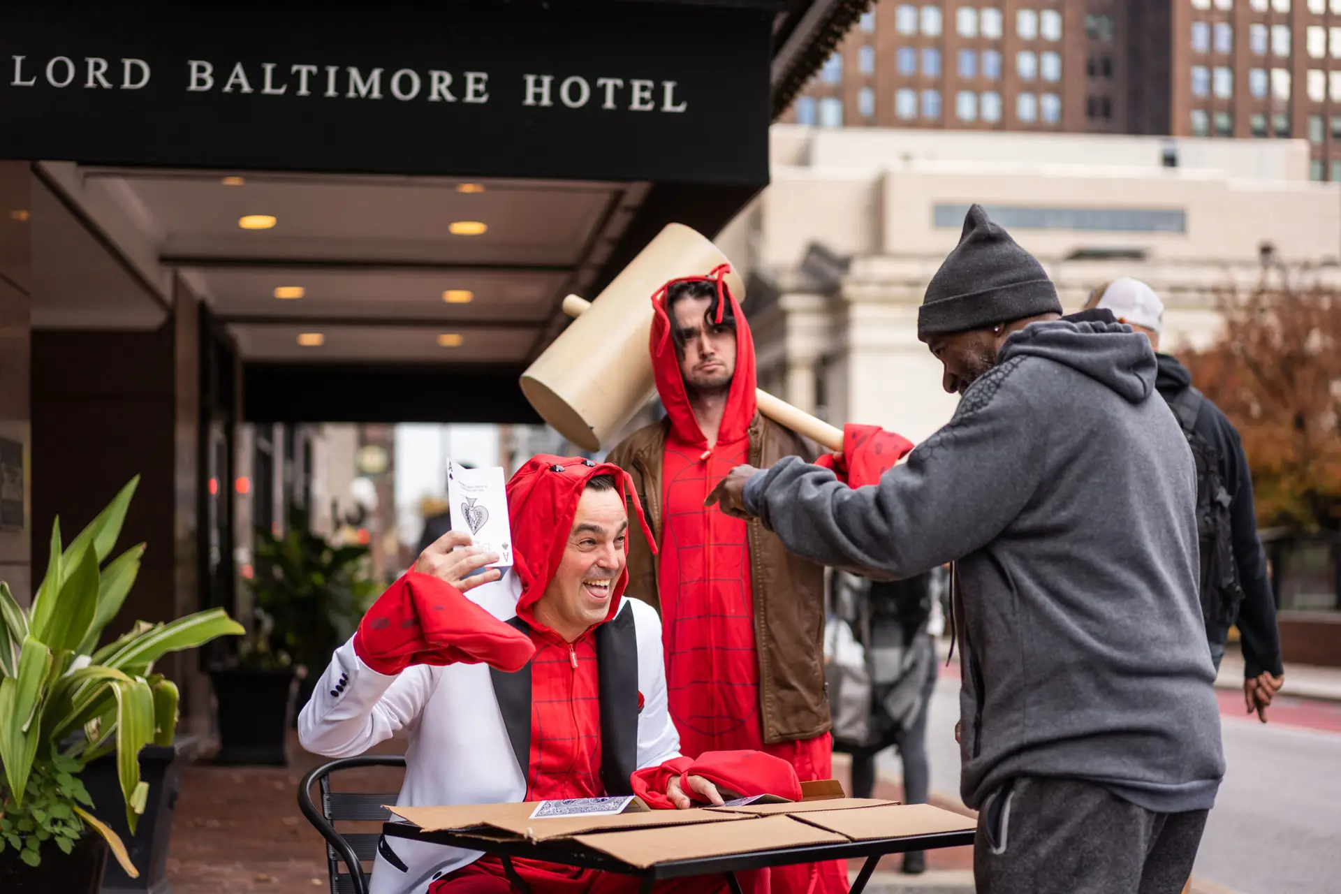 Mentalist Adam Stone dressed as a crab performing three card monte for passersby outside the Lord Baltimore Hotel