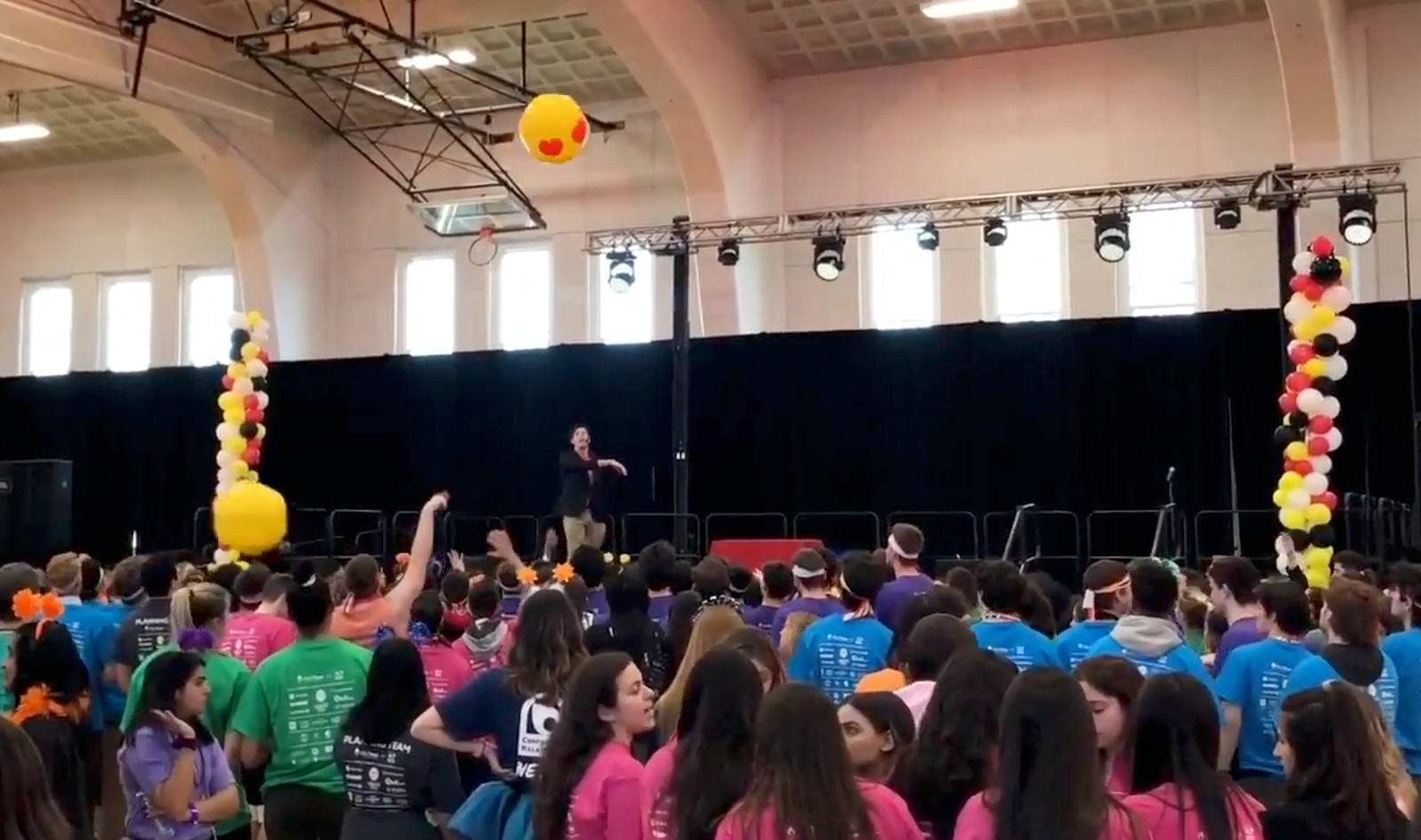 Adam Stone Live at Terp Thon University of Maryland Adam Stone Magic Adam Stone Magic Adam Stone Performing a Mentalism Show on Stage at Terp Thon at the University of Maryland Hitting Large Emoji Beach Balls into the Audience to Select Random Volunteers