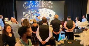 mentalist Adam Stone Performing on Stage in a s Suit and Fedora for a Costumed Gatsby Party Audience