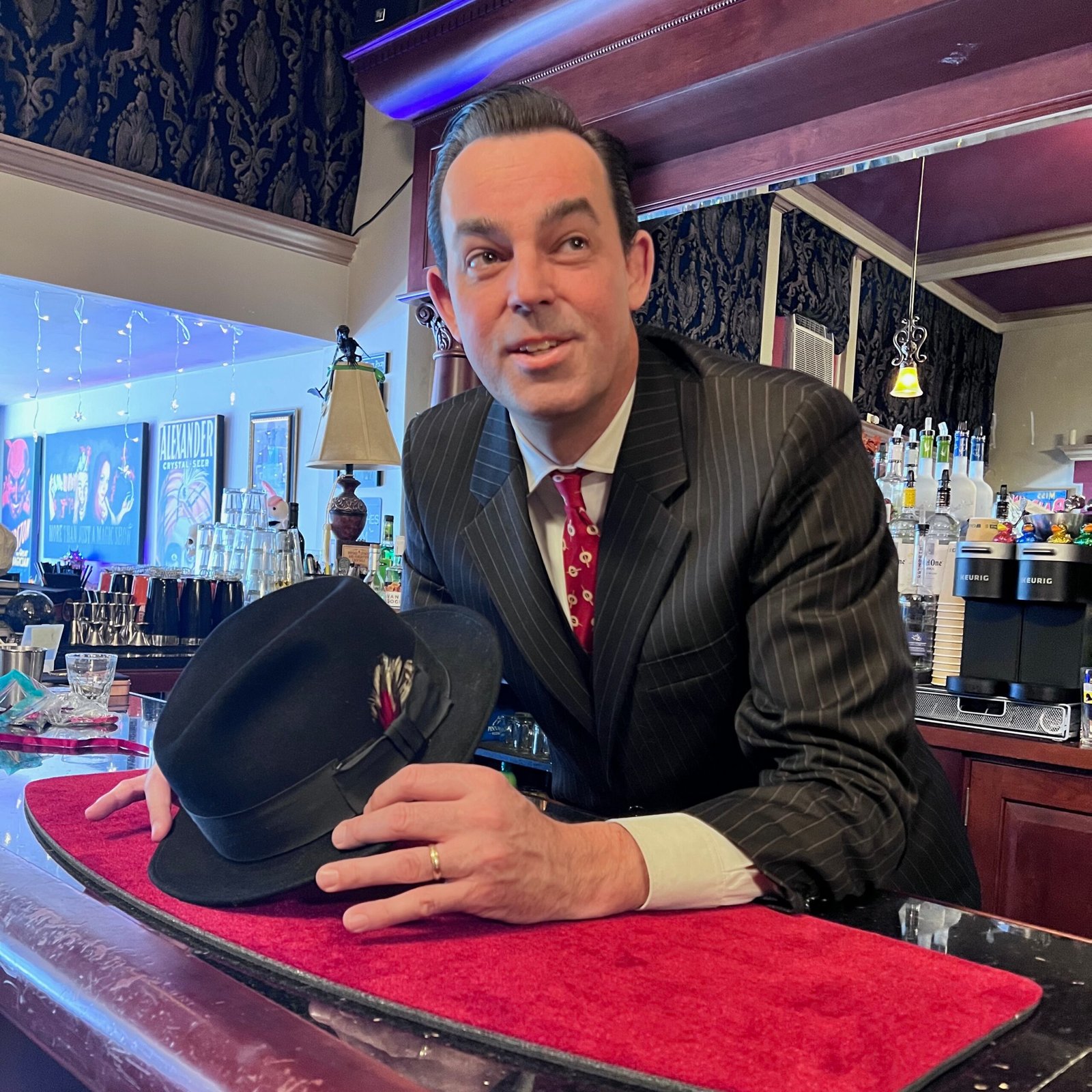 Adam Stone Gatsby Party Entertainment Adam Stone Magic Adam Stone Magic Mentalist Adam Stone in Gatsby Party Attire Standing Behind the Bar with Hat in Hand