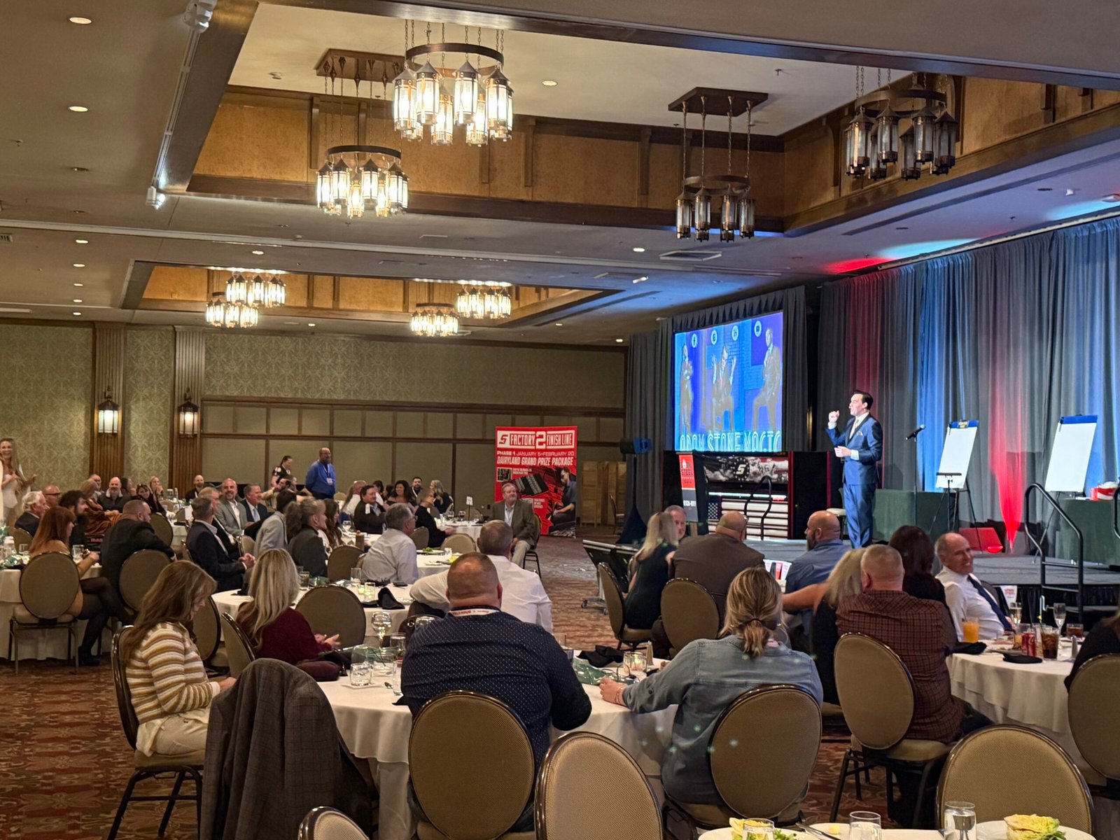Corporate Mentalist Adam Stone Performing on Stage with Audience Members at the Snap on Tools Corporate Event