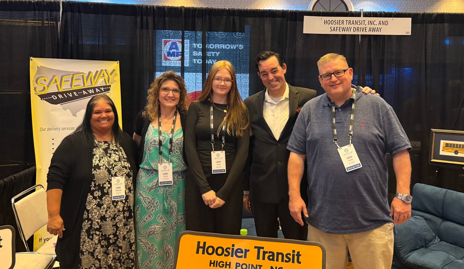 Adam Stone Trade Show Booth Performance Adam Stone Magic Mentalist Adam Stone Standing at a Trade Show Booth with a Corporate Sales Team