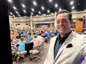 Mentalist Adam Stone Standing Backstage at the Buffalo Convention Center Preparing to Perform for an Audience of  Guests Seated at Round Tables for the Williams Syndrome Association