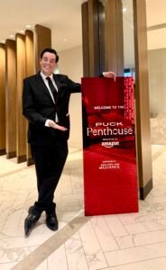 Adam Stone White House Correspondents Dinner Pre show Puck Penthouse Adam Stone Magic Corporate Mentalist Adam Stone in a Tuxedo Standing in Front of the Puck Penthouse Sign at the White House Correspondents Dinner Pre show in Washington Dc