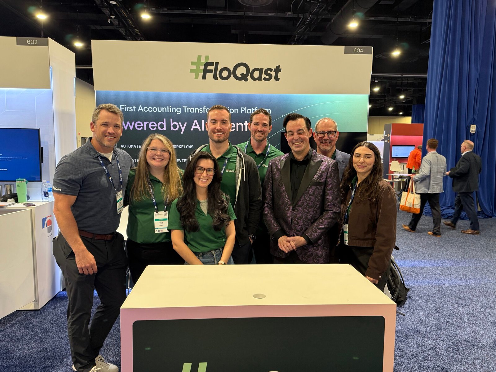 Corporate Mentalist Adam Stone Standing at the Flow Cast Trade Show Booth with the Team at the Walter E Washington Convention Center in Washington Dc