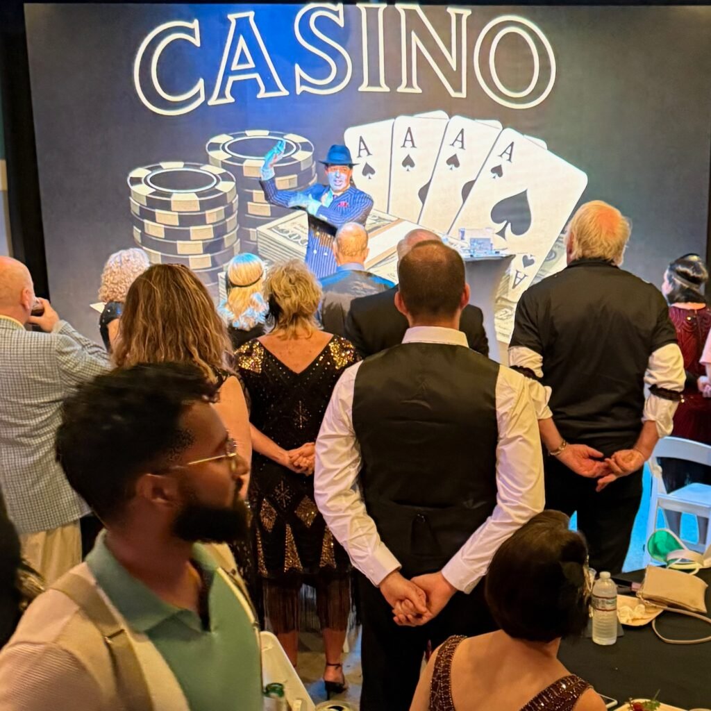 Mentalist Adam Stone Performing on Stage in a S Suit and Fedora for a Costumed Gatsby Party Audience Magician Vs Mentalist